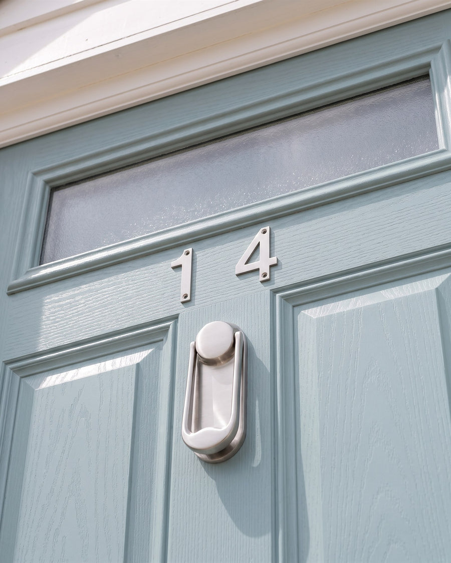 Brushed 316 stainless steel ingot door knocker below stainless numbers 14 on a duck-egg blue composite door