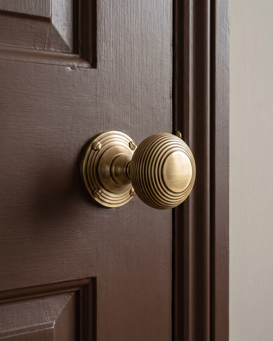 Antique brass reeded mortice knob on a chocolate brown painted internal door