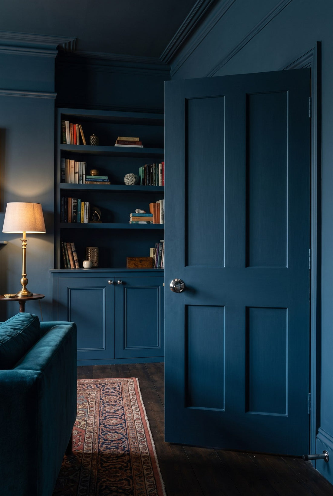 Ink blue colour-drenched Edwardian living room with a panelled door fitted with a polished nickel reeded knob and cylinder stop, and alcove shelves above cupboards with polished nickel reeded cupboard knobs