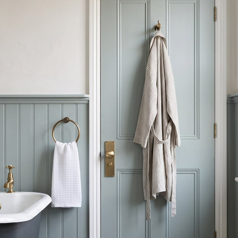 Period bathroom with antique brass towel ring and door handle