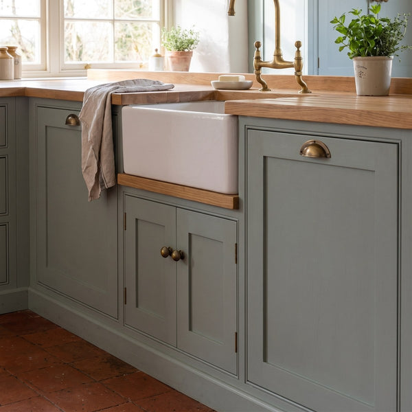 Painted kitchen cupboards with antique brass cup pulls and knobs